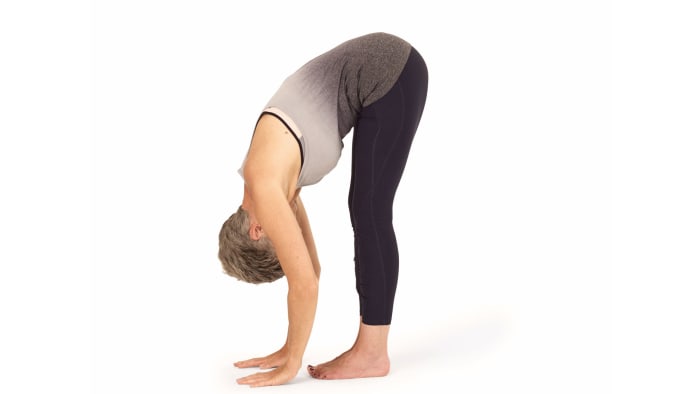 1. Stand with your feet hip distance apart so the outside edges of your feet are parallel. 2. Bring your hands to your hips, inhale deeply and lengthen your spine. 3. As you exhale, hinge from your hips to fold forwards. 4 Once you start feeling a stretch, release your hands down to the floor, or take hold of your shins, ankles or big toes. On each inhale, lengthen your spine, and as you exhale, fold deeper into the pose to intensify the stretch. 5. Hold 10 breaths.See also More Forward Bend Poses