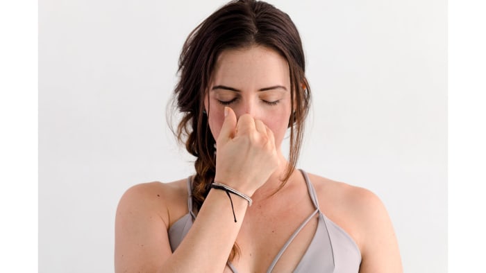 While comfortably seated, fold the index and middle fingers of your right hand back onto your palm. Breathe through both nostrils. With your right ring finger, close your left nostril. Inhale through your right nostril. Pause. Close your right nostril with your thumb and breathe out through your left nostril. Pause. Inhale through your left nostril. Pause. Close your left nostril with your ring finger and breathe out through your right. Continue in this manner: inhaling through the nostril you just breathed out of, adding a slight pause at the top and the bottom of the breath. After 10 rounds, remove your hand and feel the cool ease, when stagnation is released, of breathing through both nostrils. See also Alternate Nostril Breathing to Help you Sleep