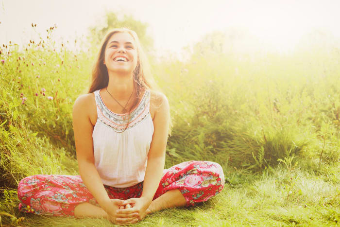 woman in Cobbler's Pose outside