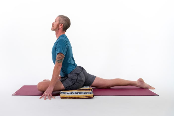 From Downward-Facing Dog, roll your body forward as if you were moving into a Plank Pose. Then bring your left shin to the ground. Keep your left hip directly behind your left wrist. Extend through your elongated right leg. Option: gently walk your hands forward and lower your elbows to rest your forearms on the mat or on blocks. You can place a blanket or block under your front hip for extra support and to help your hips heavy toward the earth. Hold for 5-10 breaths. Repeat on the other side.Try these blocks to support your hips or forearms in Pigeon Pose.