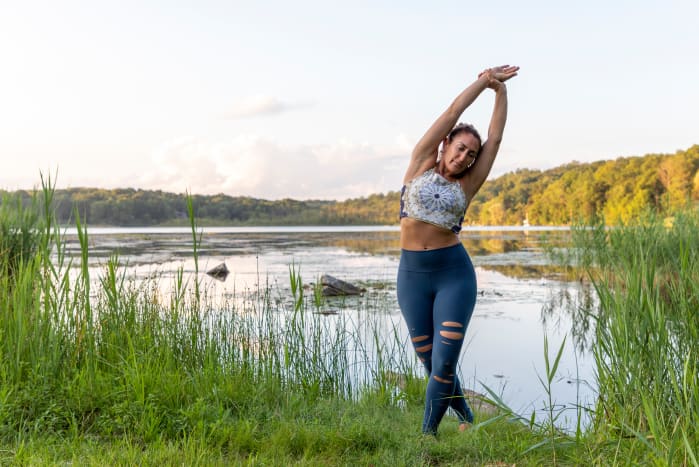 Stand at the top of your yoga mat in Tadasana (Mountain Pose) and take a few grounding breaths in and out through your nose. Step the ball of your right foot behind your left foot. Grab your right wrist with your left fingers and side bend to your left. On your inhalations, find length in your side body. On your exhalations, invite a sense of release and surrender. Hold for 3-5 breaths. Uncross your ankles and forward fold over your legs into Uttansana (Standing Forward Bend).see also Stand Taller With These Side Body Lengthening Poses